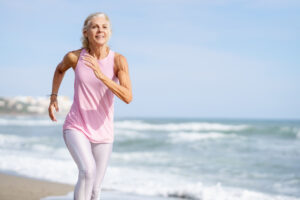 mature woman running along the shore of the beach 2022 03 16 00 25 03 utc